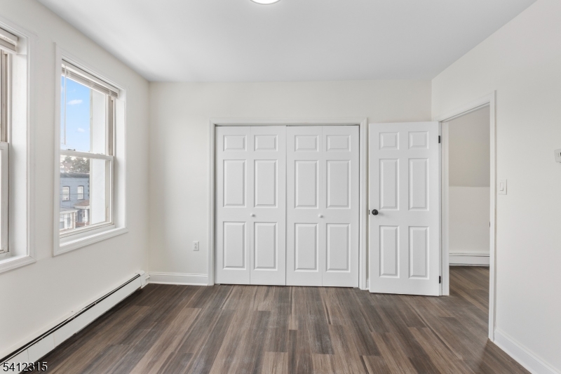 676 Chestnut Street, Unit 3 Kearny, NJ 07032 - Photo 15 of 21 a view of an empty room with wooden floor and a window