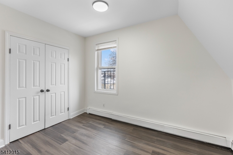676 Chestnut Street, Unit 3 Kearny, NJ 07032 - Photo 17 of 21 a view of an empty room with wooden floor and a window