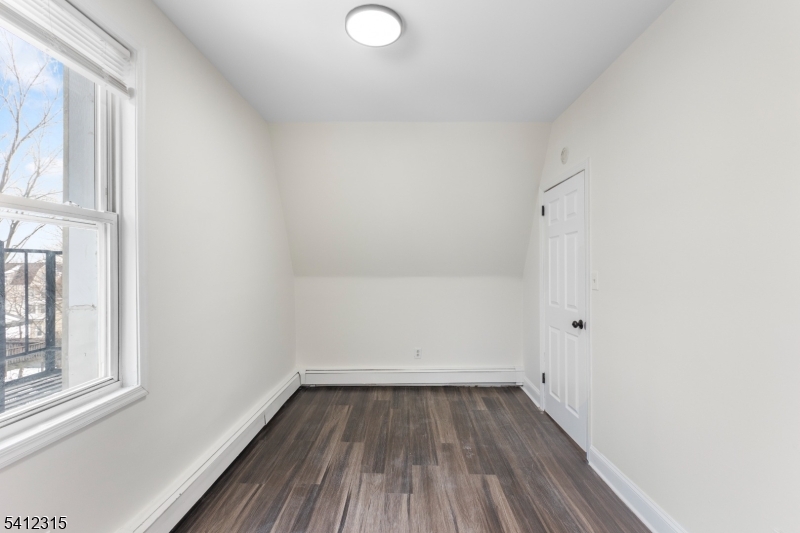 676 Chestnut Street, Unit 3 Kearny, NJ 07032 - Photo 18 of 21 a view of a room with wooden floor and window