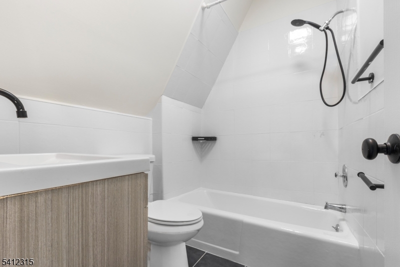 676 Chestnut Street, Unit 3 Kearny, NJ 07032 - Photo 19 of 21 a bathroom with a shower and a toilet