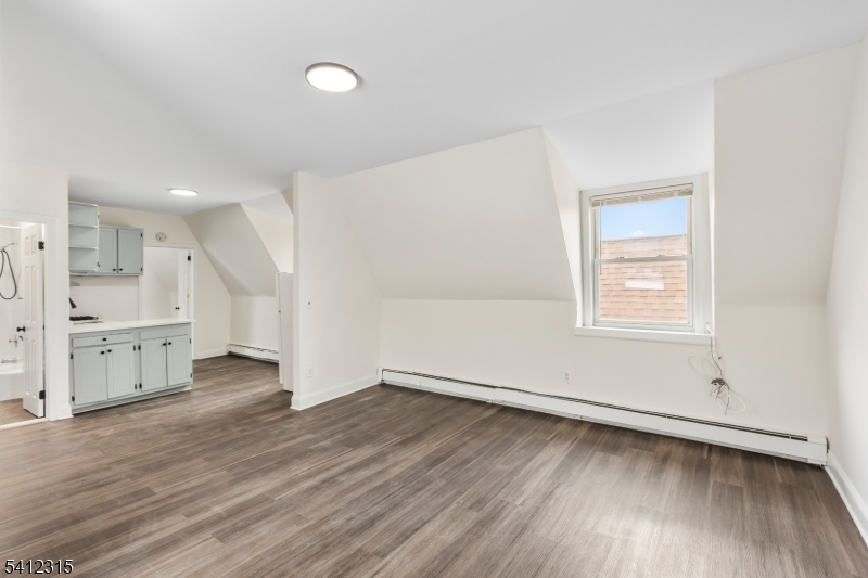 676 Chestnut Street, Unit 3 Kearny, NJ 07032 - Photo 4 of 21 an empty room with wooden floor and windows