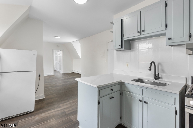 676 Chestnut Street, Unit 3 Kearny, NJ 07032 - Photo 8 of 21 a kitchen with sink cabinets and refrigerator