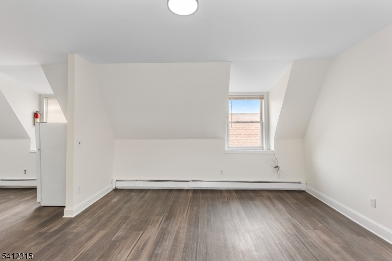 676 Chestnut Street, Unit 3 Kearny, NJ 07032 - Photo 9 of 21 an empty room with wooden floor and window
