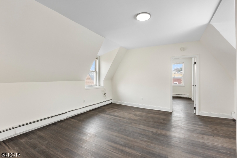676 Chestnut Street, Unit 3 Kearny, NJ 07032 - Photo 10 of 21 an empty room with wooden floor and windows