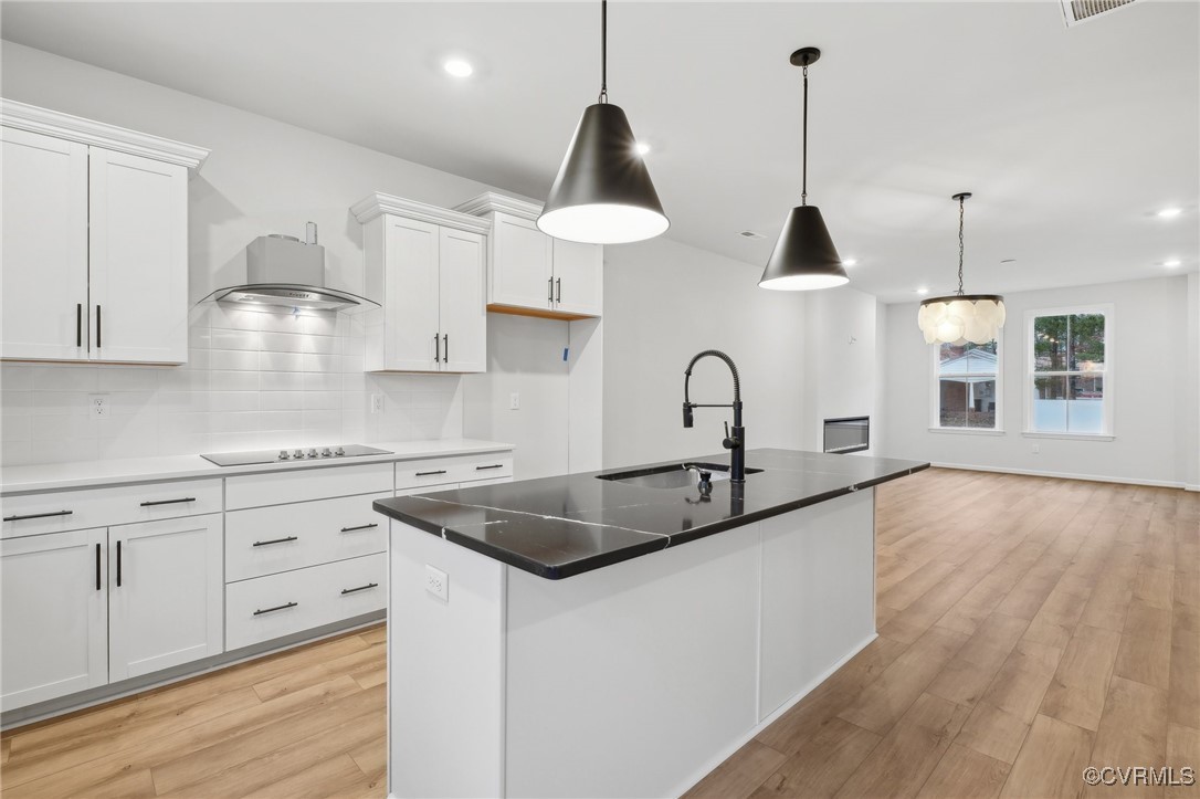218 That Way Midlothian, VA 23114 - Photo 3 of 22 a kitchen with stainless steel appliances granite countertop a sink a stove and a wooden floor