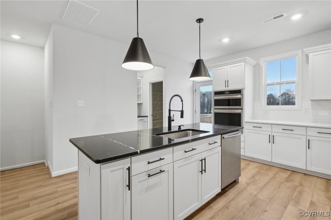 218 That Way Midlothian, VA 23114 - Photo 4 of 22 a kitchen with white cabinets and sink