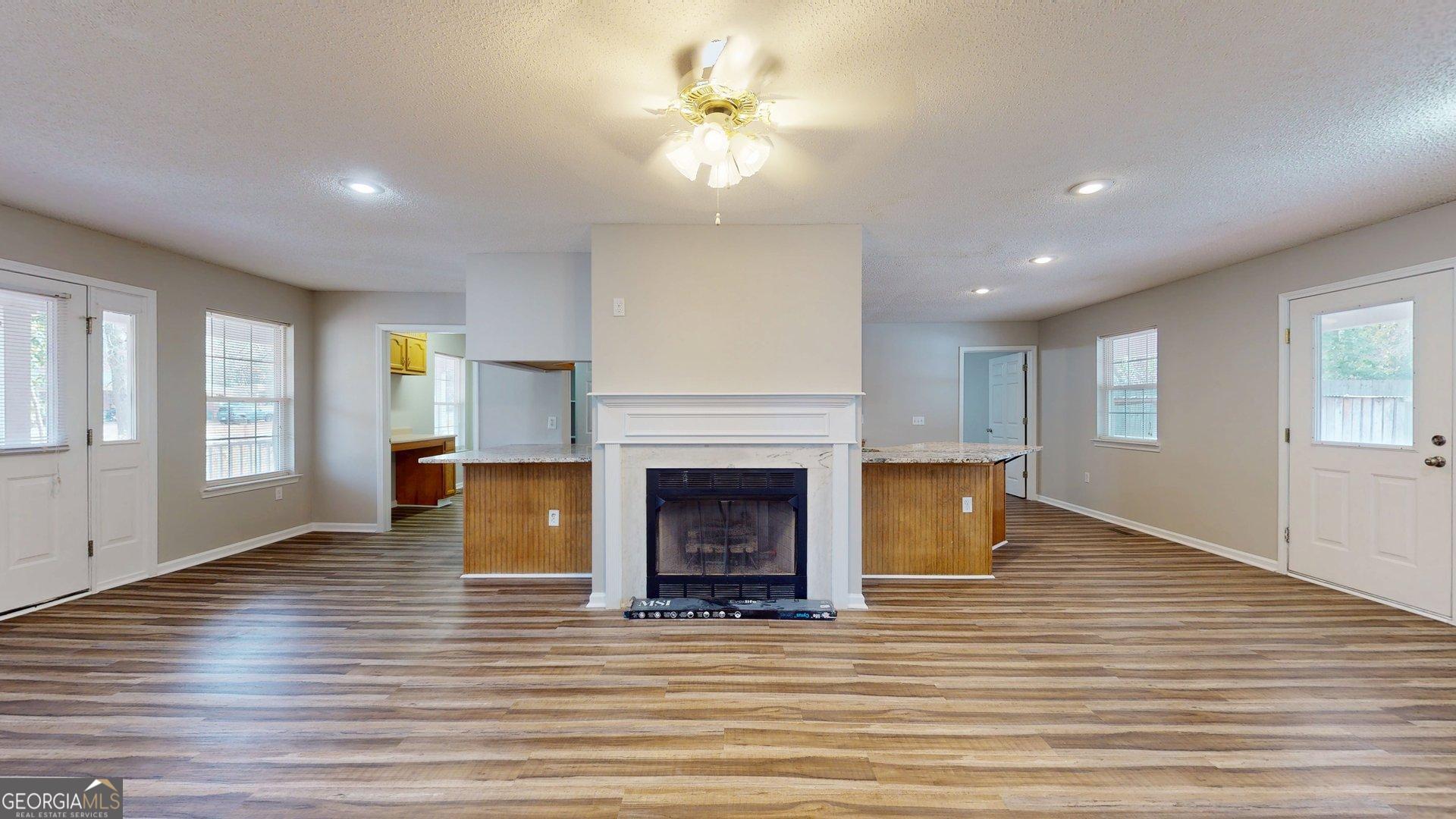 125 Harden Road Statesboro, GA 30458 - Photo 13 of 35 a view of a livingroom with a fireplace window and wooden floor