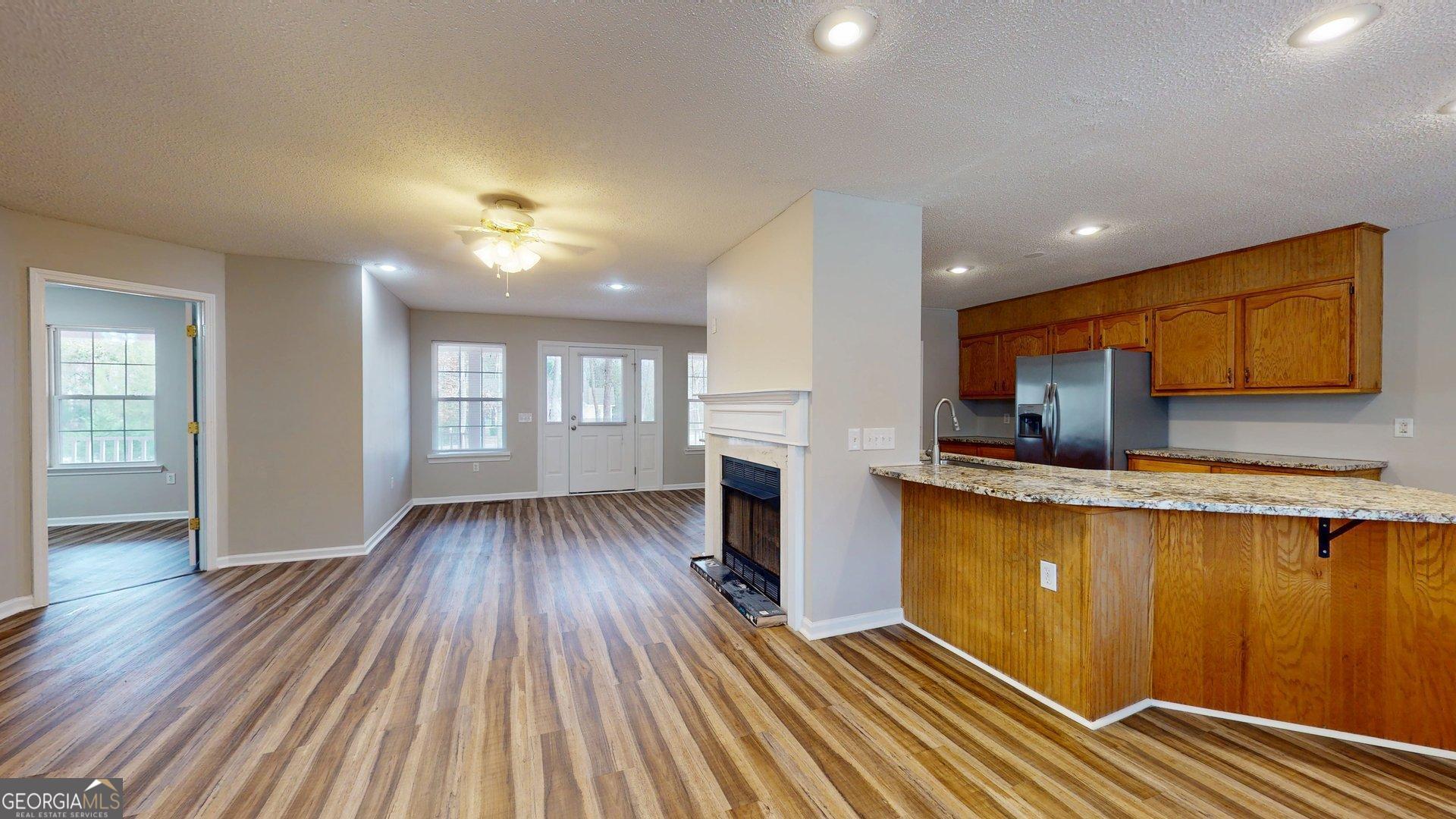125 Harden Road Statesboro, GA 30458 - Photo 15 of 35 a kitchen with wooden floors and wooden cabinets