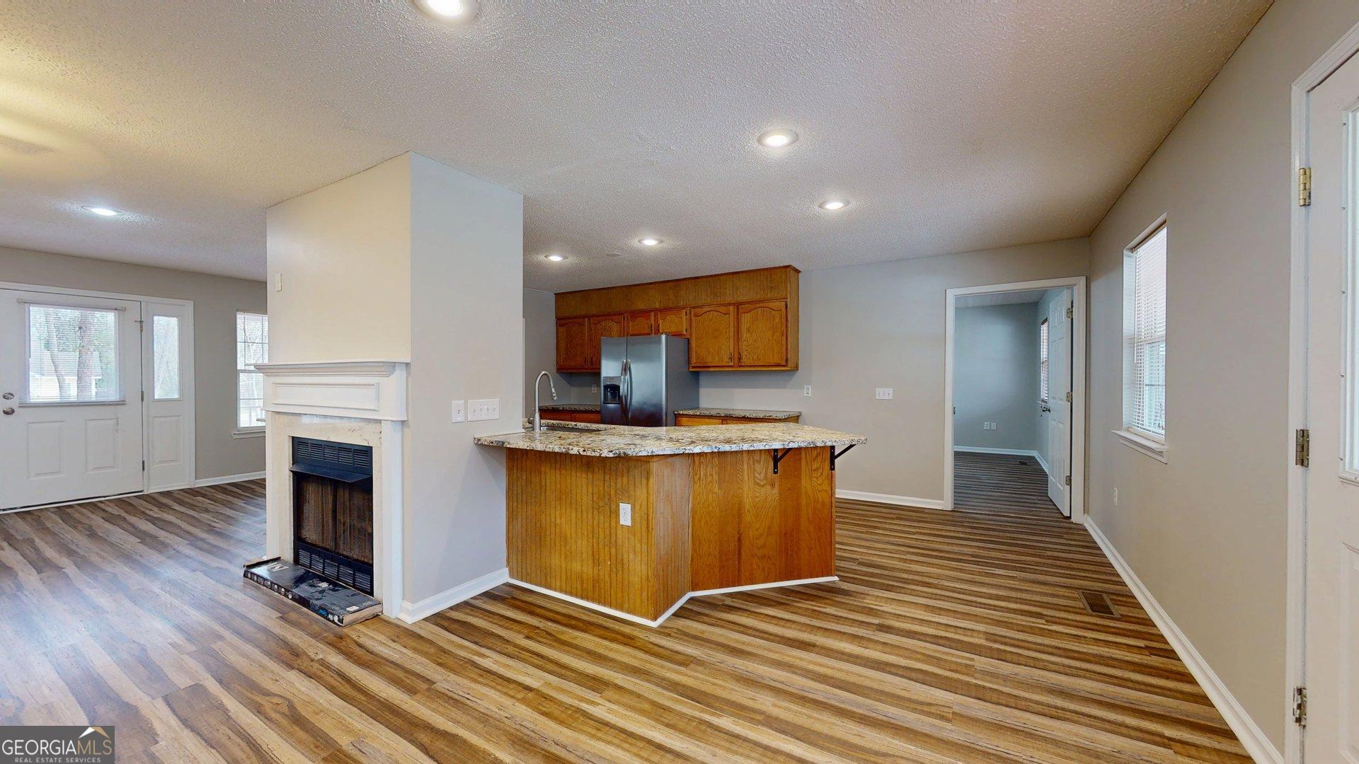 125 Harden Road Statesboro, GA 30458 - Photo 16 of 35 a living room with stainless steel appliances furniture a fireplace and wooden floor