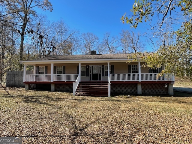 125 Harden Road Statesboro, GA 30458 - Photo 2 of 35 a view of a house with a large window and wooden fence