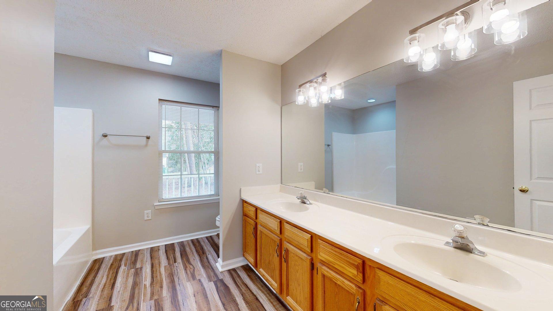 125 Harden Road Statesboro, GA 30458 - Photo 23 of 35 a bathroom with a sink a mirror and a shower
