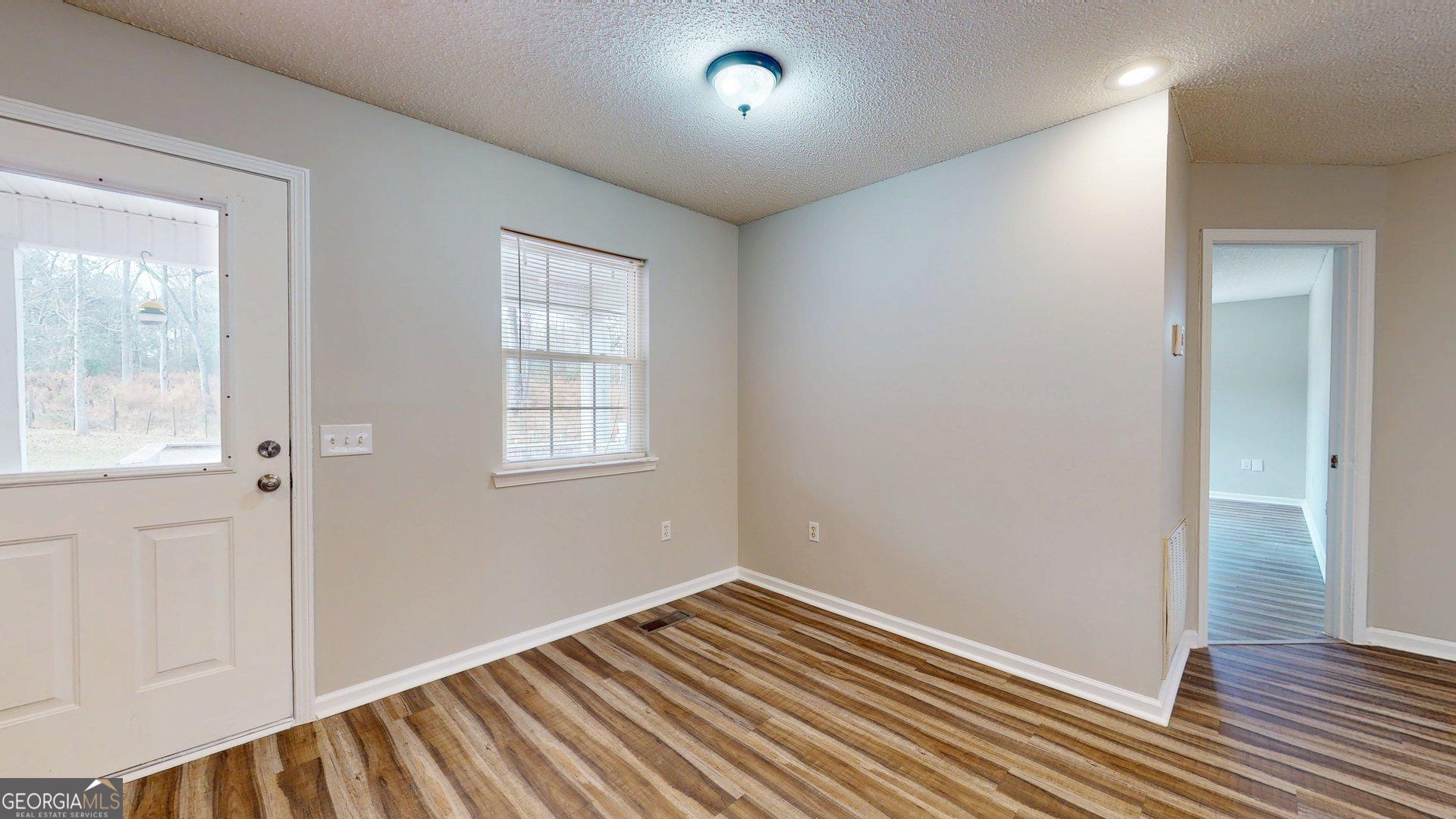 125 Harden Road Statesboro, GA 30458 - Photo 25 of 35 a view of an empty room with wooden floor and a window