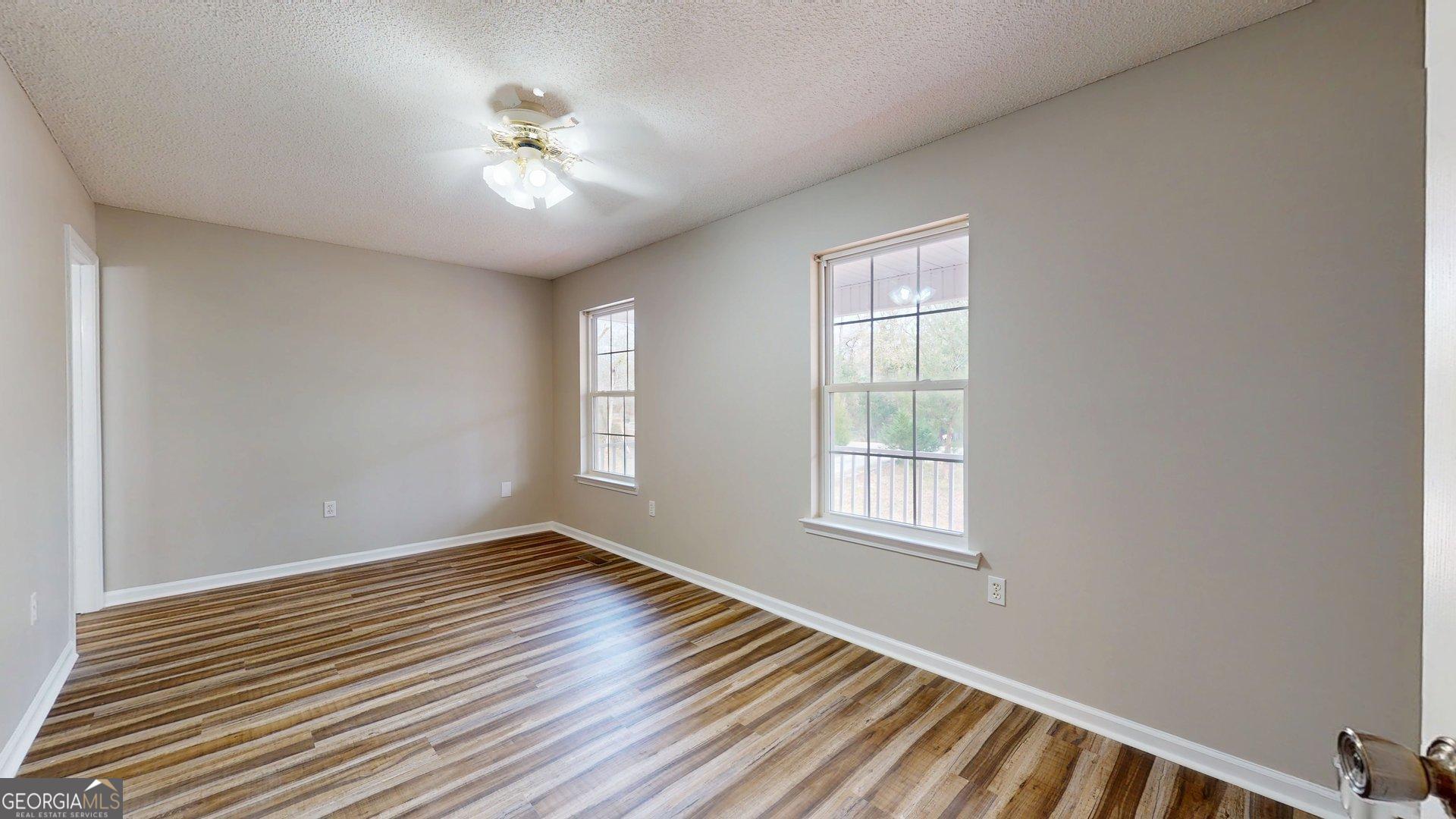 125 Harden Road Statesboro, GA 30458 - Photo 27 of 35 a view of an empty room with wooden floor and a window