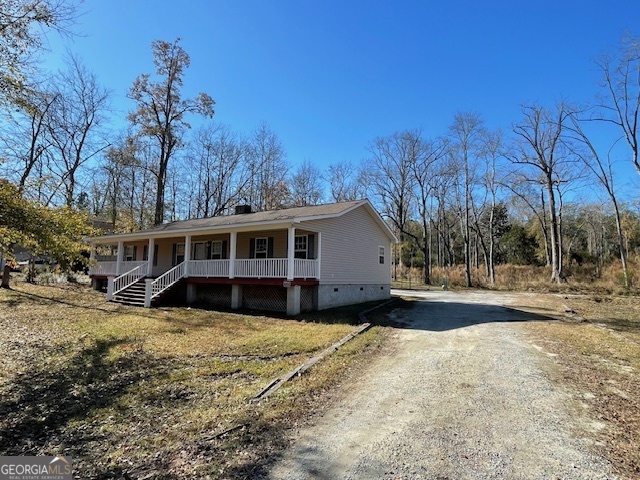 125 Harden Road Statesboro, GA 30458 - Photo 5 of 35 a view of a house with a yard covered with snow in the background