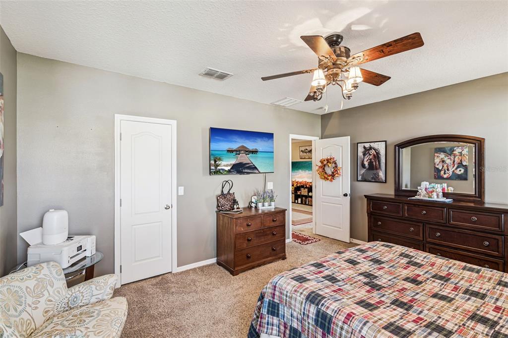 1183 Berkley Ridge Lane Auburndale, FL 33823 - Photo 12 of 25 a bedroom with a bed and a dresser in it