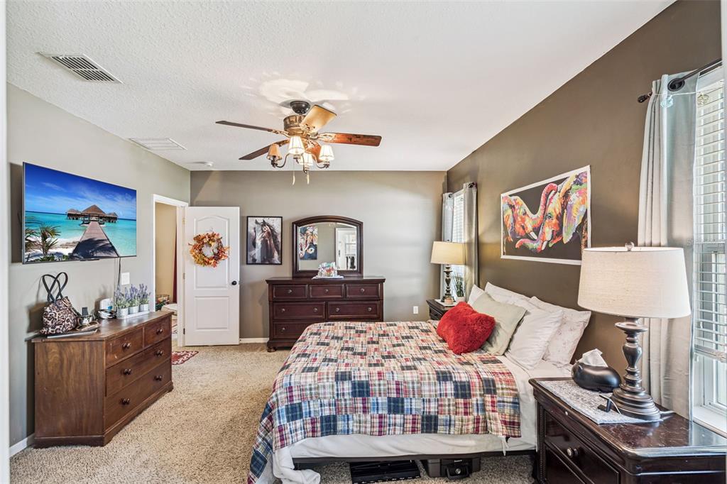 1183 Berkley Ridge Lane Auburndale, FL 33823 - Photo 13 of 25 a bedroom with a bed and dresser