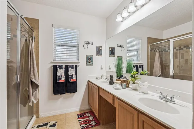a bathroom with a sink double vanity and a shower