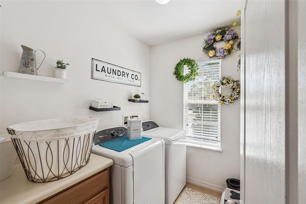 1183 Berkley Ridge Lane Auburndale, FL 33823 - Photo 17 of 25 a kitchen with a refrigerator and a window