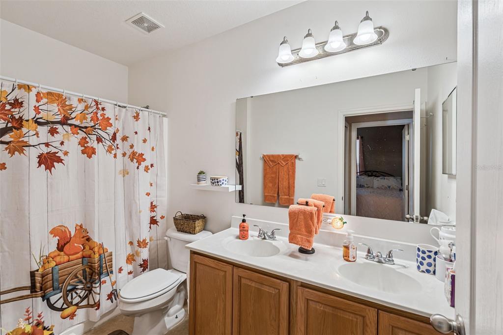 1183 Berkley Ridge Lane Auburndale, FL 33823 - Photo 18 of 25 a bathroom with a sink vanity mirror and toilet