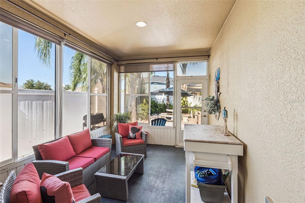 1183 Berkley Ridge Lane Auburndale, FL 33823 - Photo 20 of 25 a living room with furniture and a floor to ceiling window