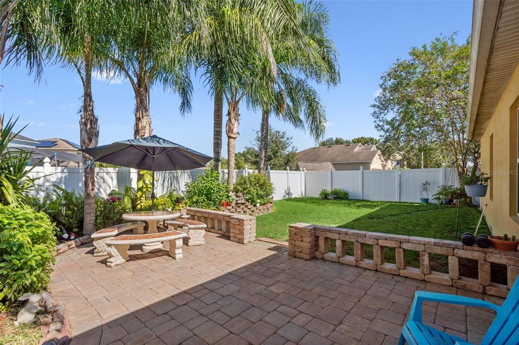 1183 Berkley Ridge Lane Auburndale, FL 33823 - Photo 23 of 25 a view of backyard with outdoor seating and trees