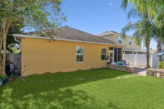 a view of a house with a yard and sitting area