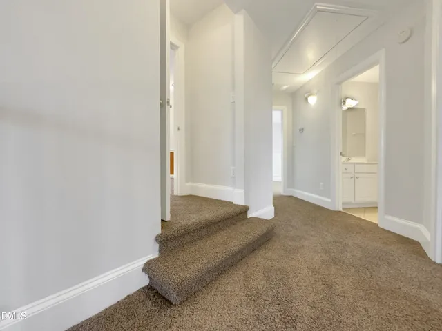 a spacious bedroom with a bed a couch and a potted plant