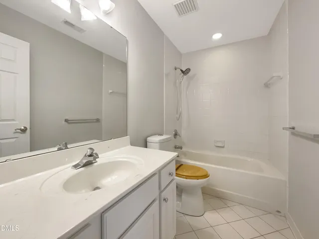 a view of an empty room with a cabinet and a window