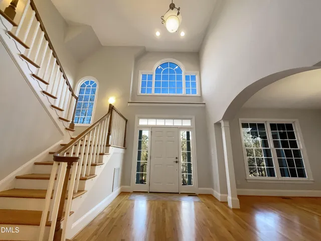 a view of entryway with wooden floor and stairs