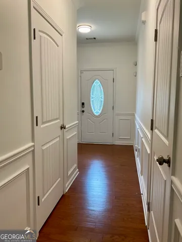 a view of a hallway with wooden floor