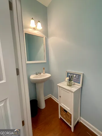 a bathroom with a sink toilet and a mirror