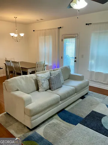 a living room with furniture and a chandelier