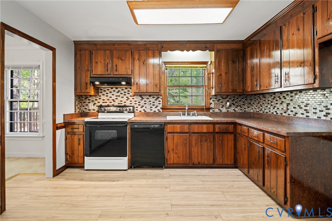 4407 Ketcham Drive Chesterfield, VA 23832 - Photo 6 of 37 a kitchen with stainless steel appliances kitchen island granite countertop a stove a sink and a microwave
