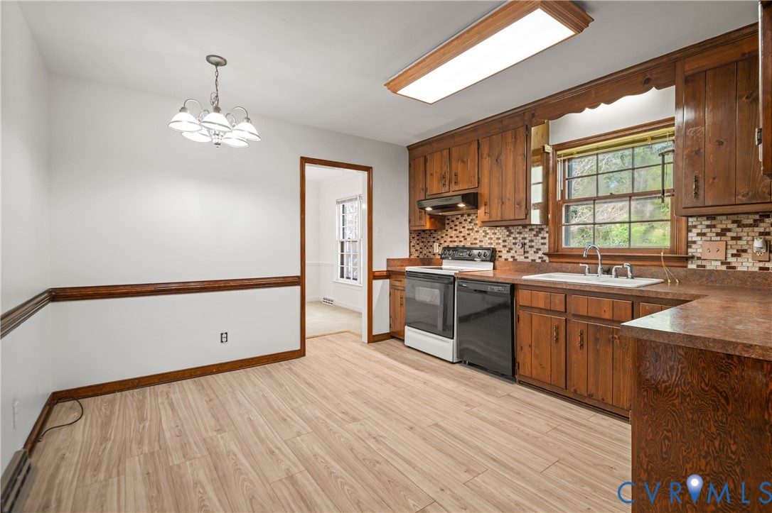 4407 Ketcham Drive Chesterfield, VA 23832 - Photo 8 of 37 a kitchen with stainless steel appliances granite countertop a sink cabinets and wooden floor