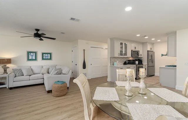 a living room with furniture and kitchen view