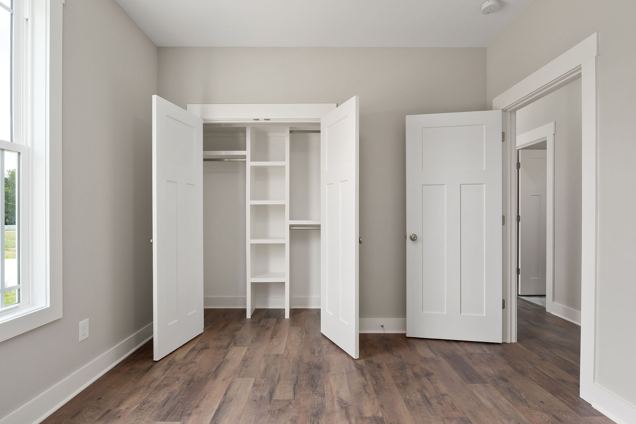 1095 Arch Cope Road Morrison, TN 37357 - Photo 17 of 29 an empty room with wooden floor & windows