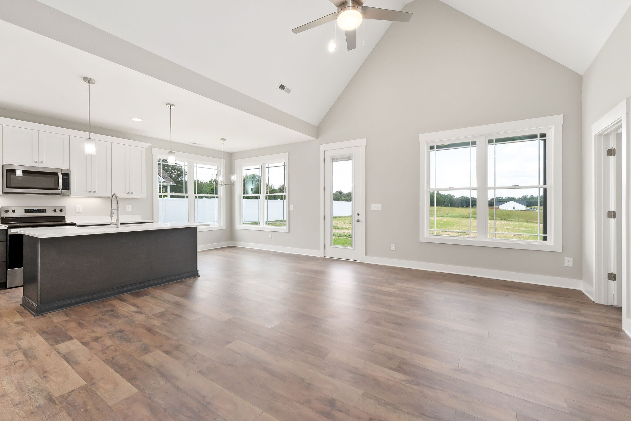 1095 Arch Cope Road Morrison, TN 37357 - Photo 4 of 29 a large kitchen with stainless steel appliances granite countertop a stove a sink a refrigerator white cabinets and wooden floor
