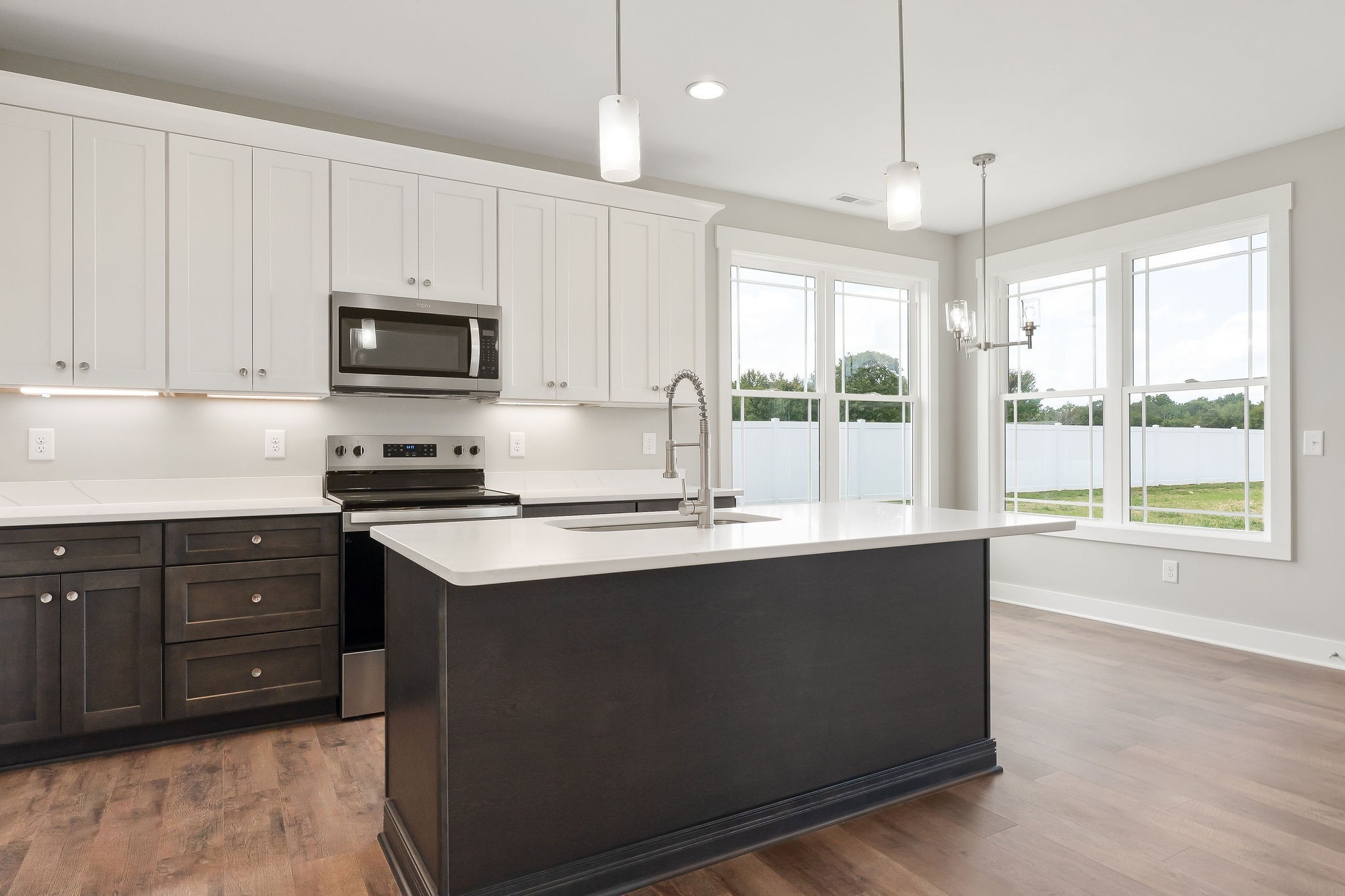 1095 Arch Cope Road Morrison, TN 37357 - Photo 7 of 29 a kitchen with kitchen island granite countertop a sink window and cabinets