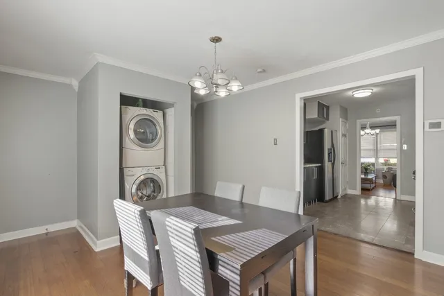a dining room with a wooden table and chairs