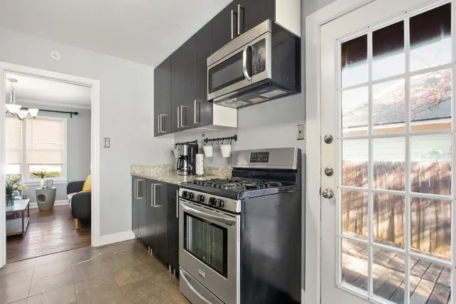 a kitchen with stainless steel appliances granite countertop a stove and a microwave