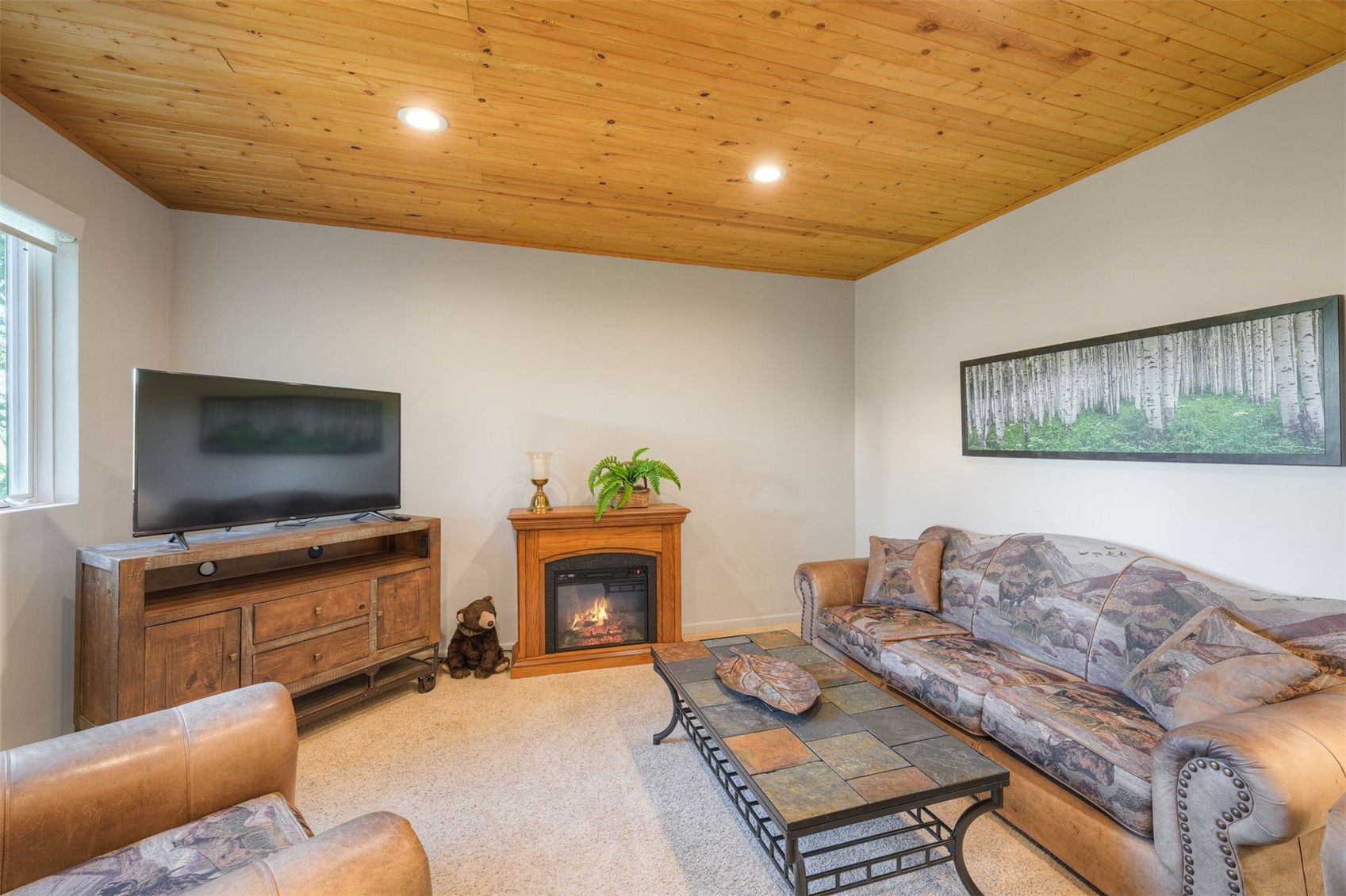 2542 Boreas Pass Road Breckenridge, CO 80424 - Photo 26 of 33 a living room with furniture a flat screen tv and a fireplace