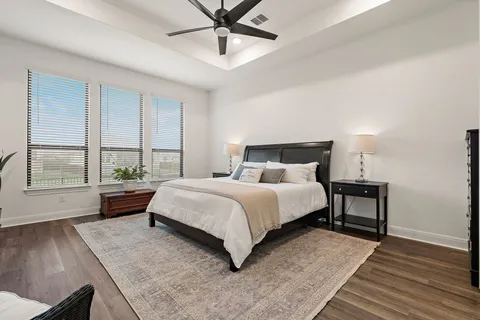 a bedroom with a large bed and a window