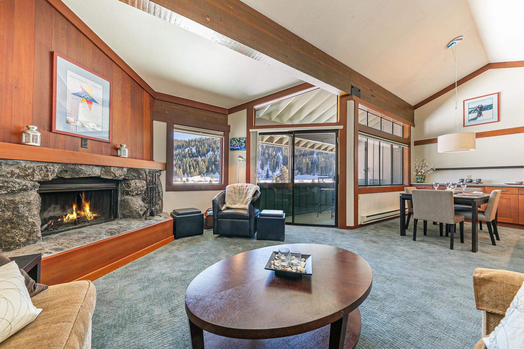 a living room with furniture a fireplace and a large window