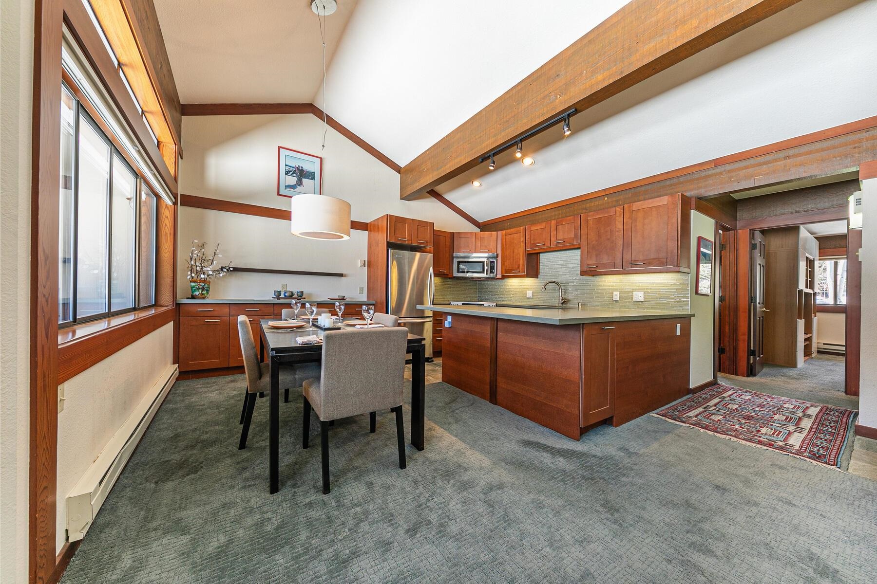 1581 Olympic Vly Road, Unit 3 Olympic Valley, CA 96146 - Photo 8 of 28 a room with stainless steel appliances kitchen island granite countertop a table chairs in it and a large window