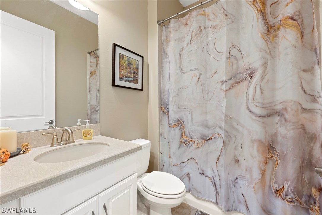 10238 Coconut Road Estero, FL 34135 - Photo 12 of 14 a bathroom with a sink toilet and a mirror