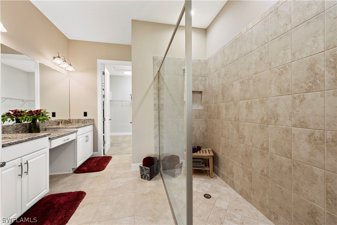 10238 Coconut Road Estero, FL 34135 - Photo 9 of 14 a bathroom with a sink a toilet and shower