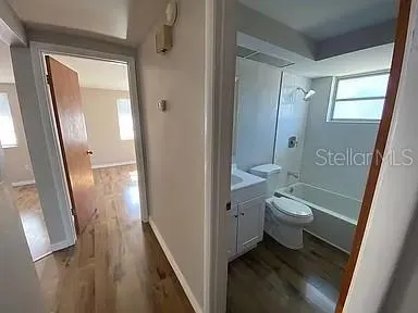 a bathroom with a granite countertop toilet sink and shower