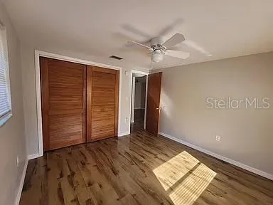 a view of an empty room with wooden floor