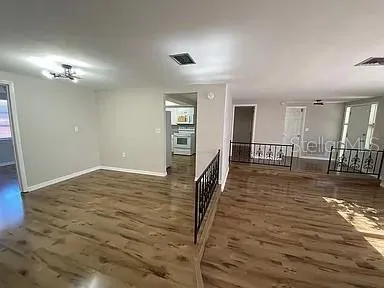 a view of a livingroom with furniture wooden floor and front door