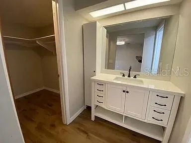 a bathroom with a double vanity sink and mirror